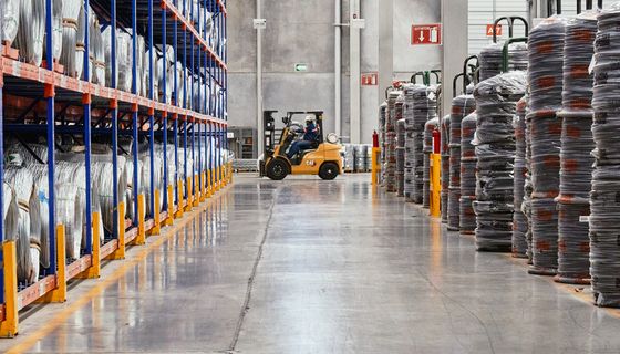 Warehouse aisle with forklift and stacked shelving